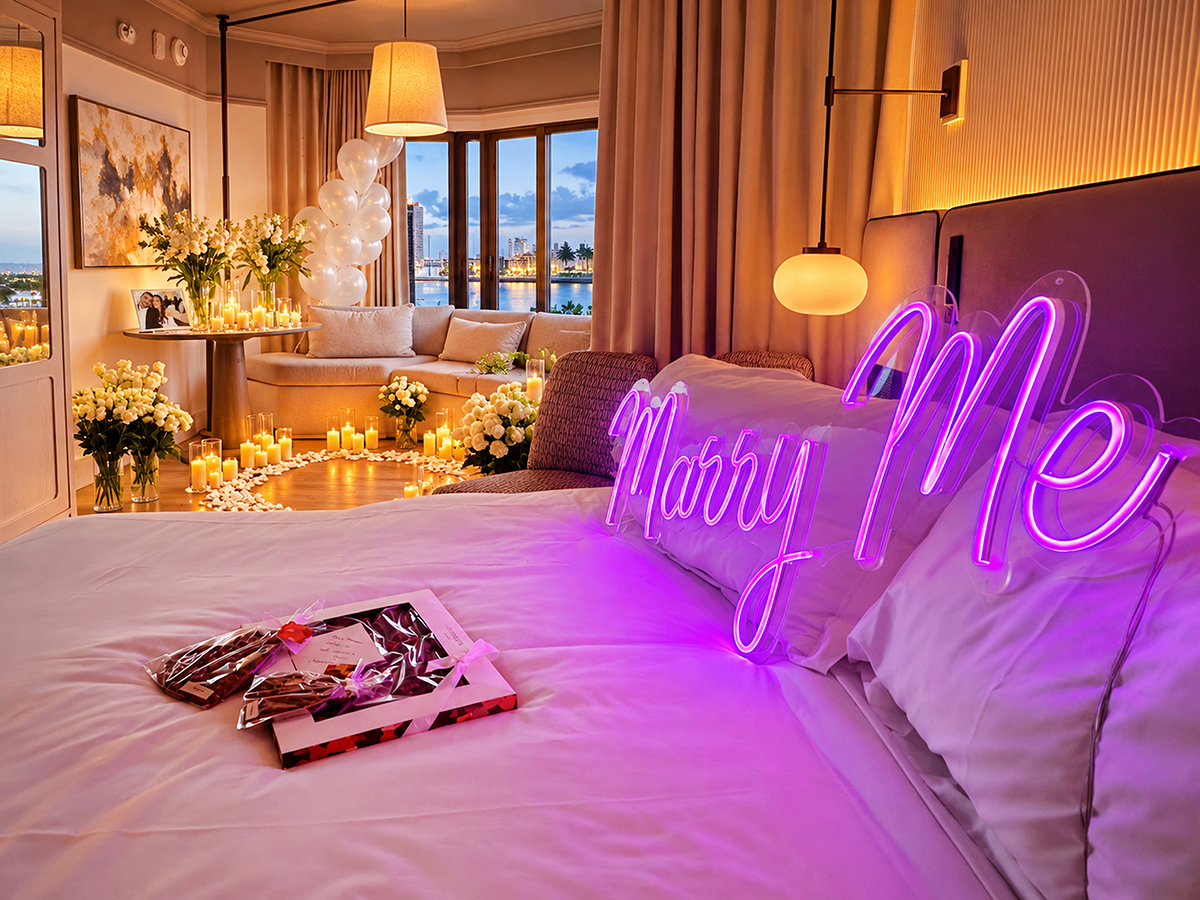 Romantic hotel room marriage proposal setup with Marry Me sign, candles, roses and South Florida view