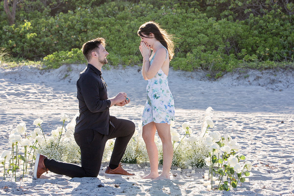 Man proposing on one knee during a Florida beach sunset, photographed by a Florida marriage proposal photographer at South Beach Park in Boca Raton.
