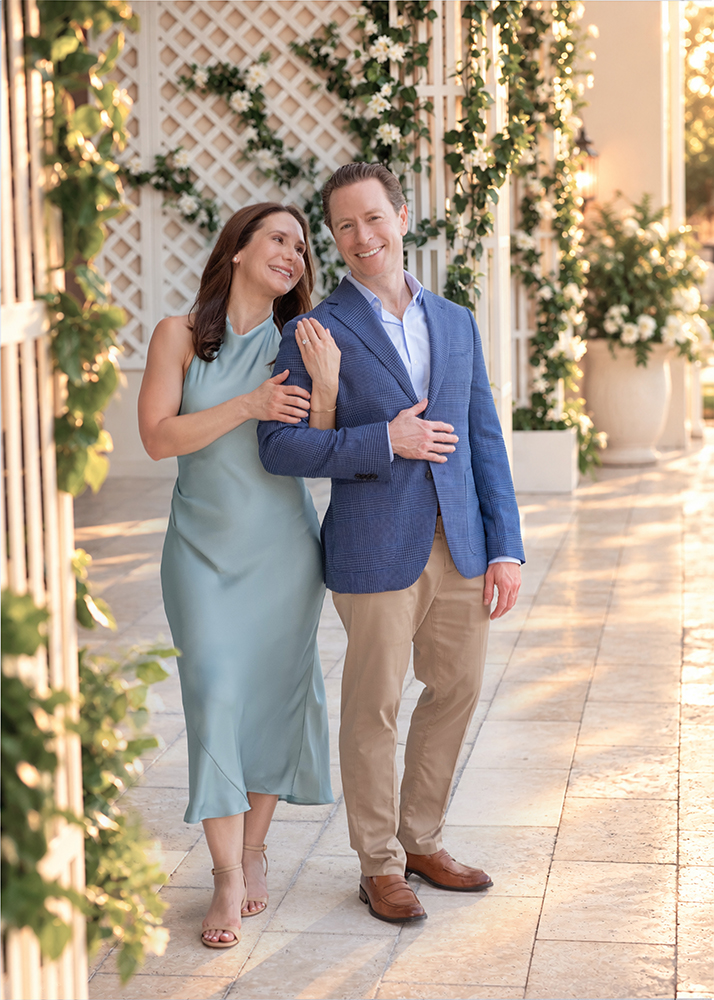 Newly engaged couple Kevin and Diana smiling together during engagement portraits at The Boca Raton in Boca Raton, Florida.