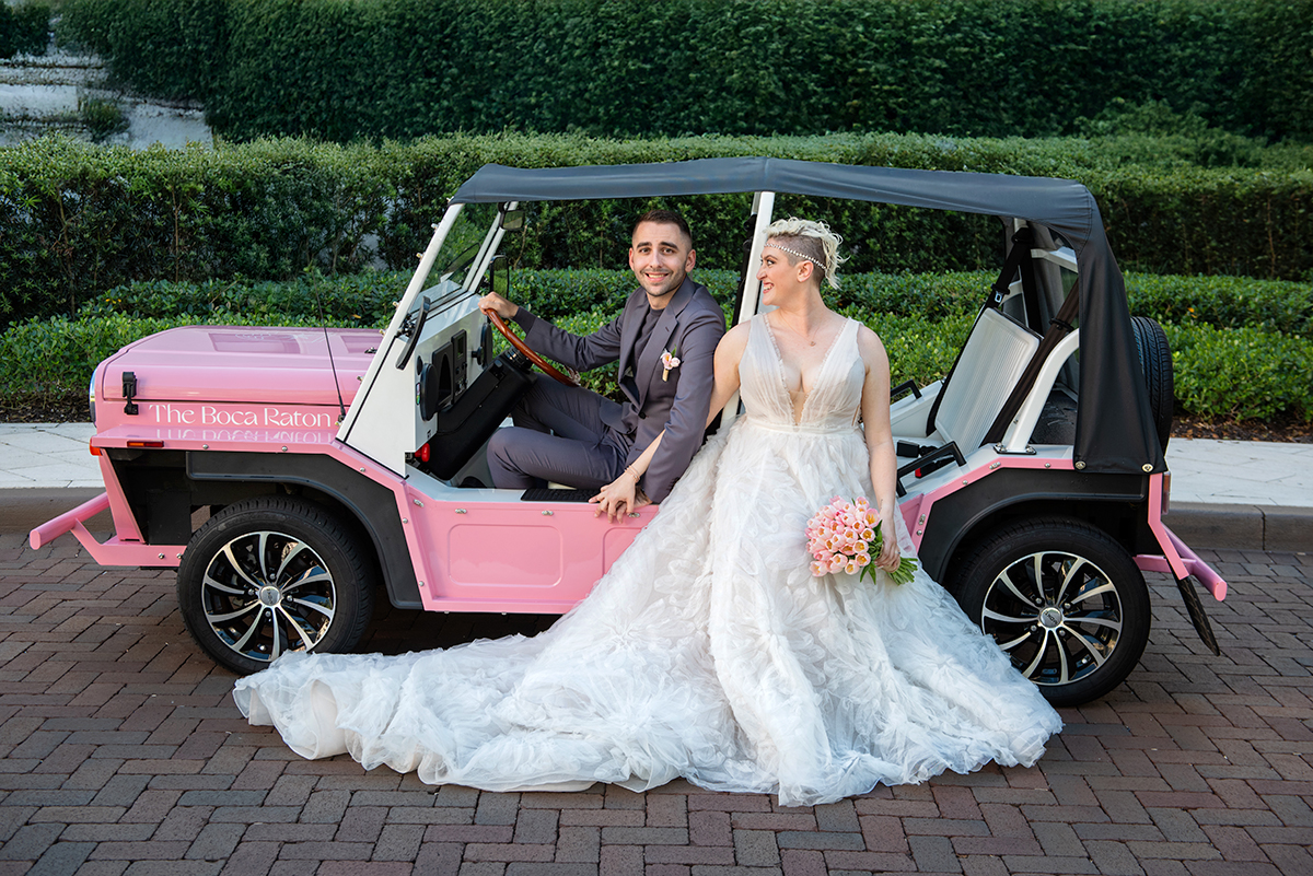 Bride and groom sitting in a car at The Boca Raton hotel.