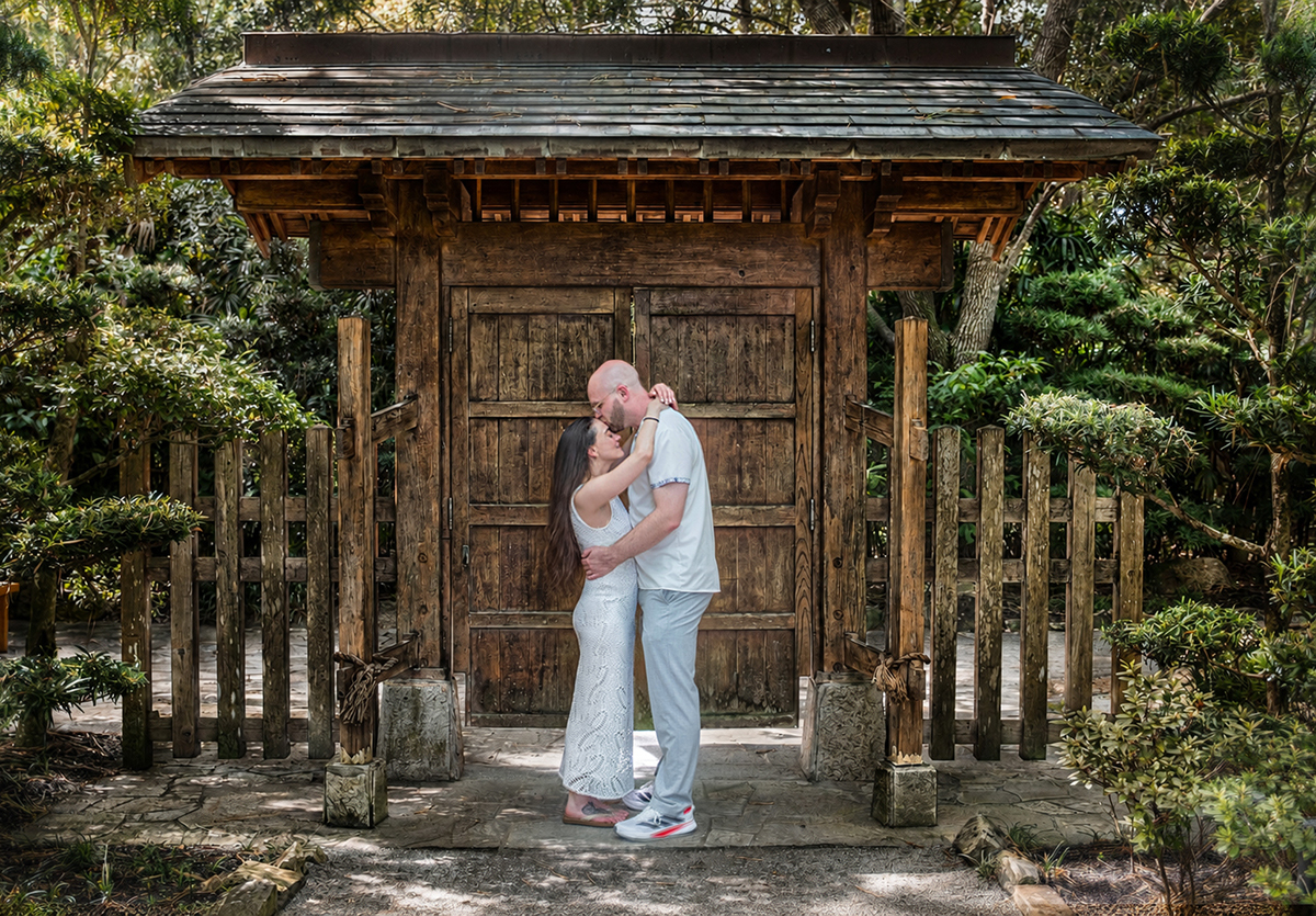 Nathan and Alyssa embrace beneath a traditional Japanese gate at the Morikami Museum and Japanese Gardens in Delray Beach, Florida, after their surprise marriage proposal.