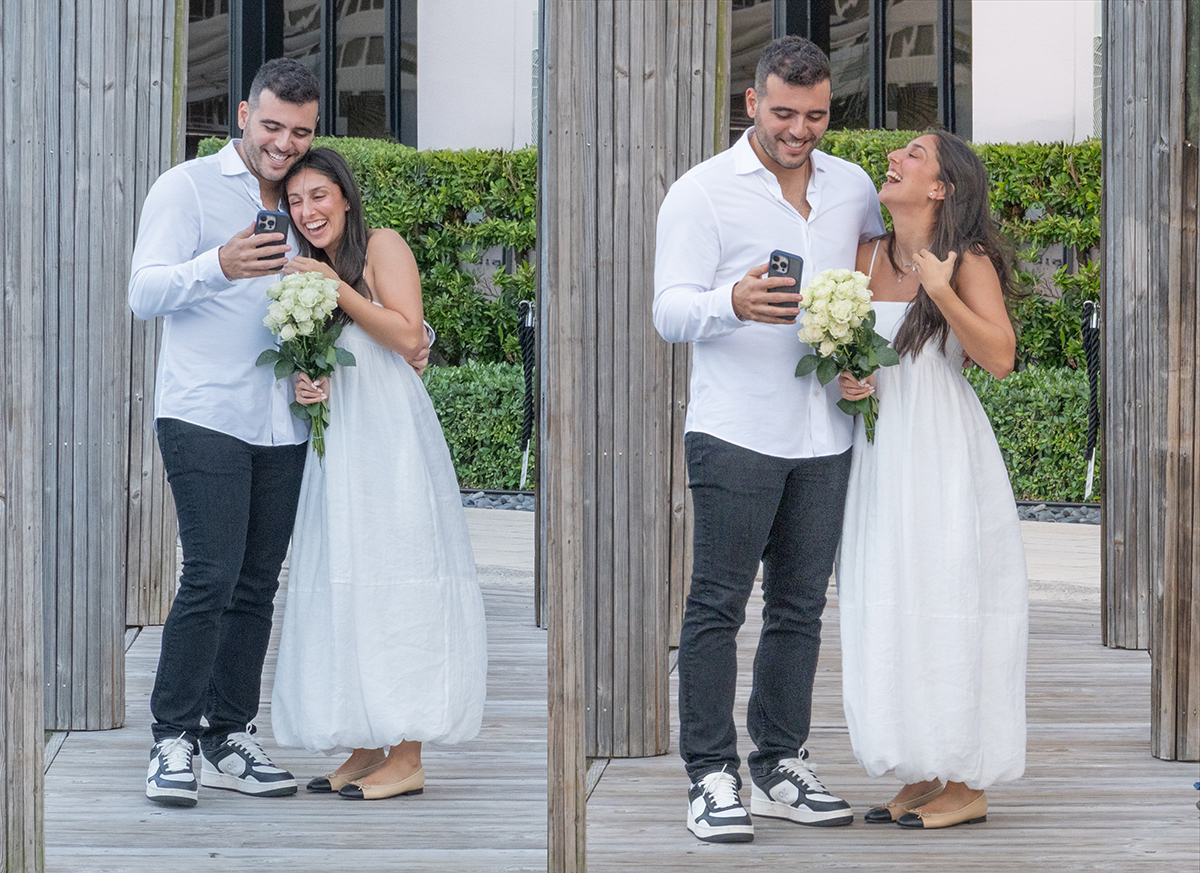 Brandon and Sydnie laughing together while sharing their engagement news by phone after their South Florida marriage proposal