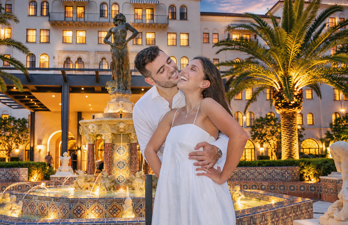 Brandon kissing Sydnie beside the historic Salome fountain at The Boca Raton during their South Florida engagement session