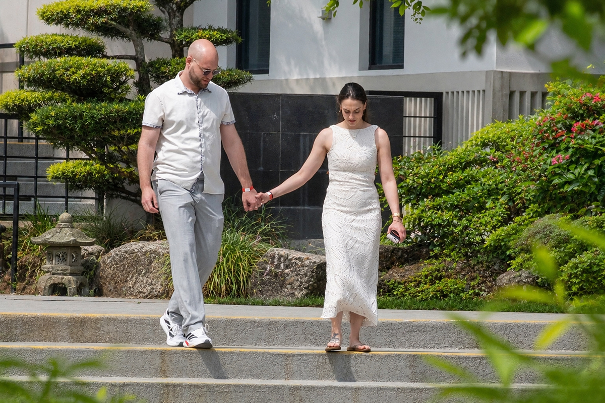 Nathan and Alyssa walk hand in hand toward the Japanese gardens before their surprise marriage proposal at the Morikami Museum and Japanese Gardens in Delray Beach, Florida.