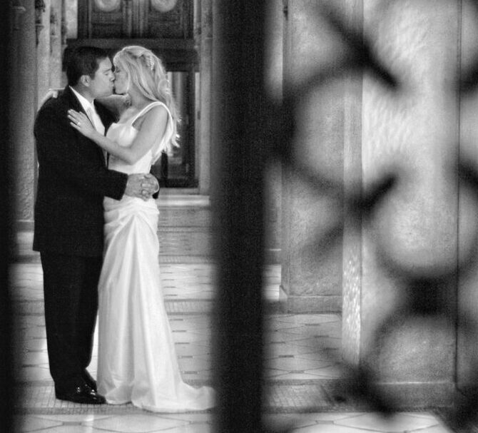 At The Breakers, Palm Beach — I found inspiration in an iron gate’s elegant design. Using selective focus, I framed the bride and groom’s kiss through the gate’s pattern, creating a blend of romance and artistry that defines my style as a South Florida wedding photographer.