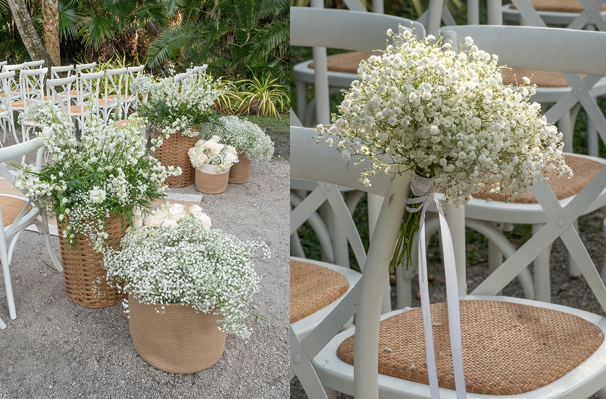 White baby’s breath bouquets tied to ceremony chairs and woven baskets filled with white florals at Bonnet House wedding ceremony in Fort Lauderdale, planned by Angela Spera.