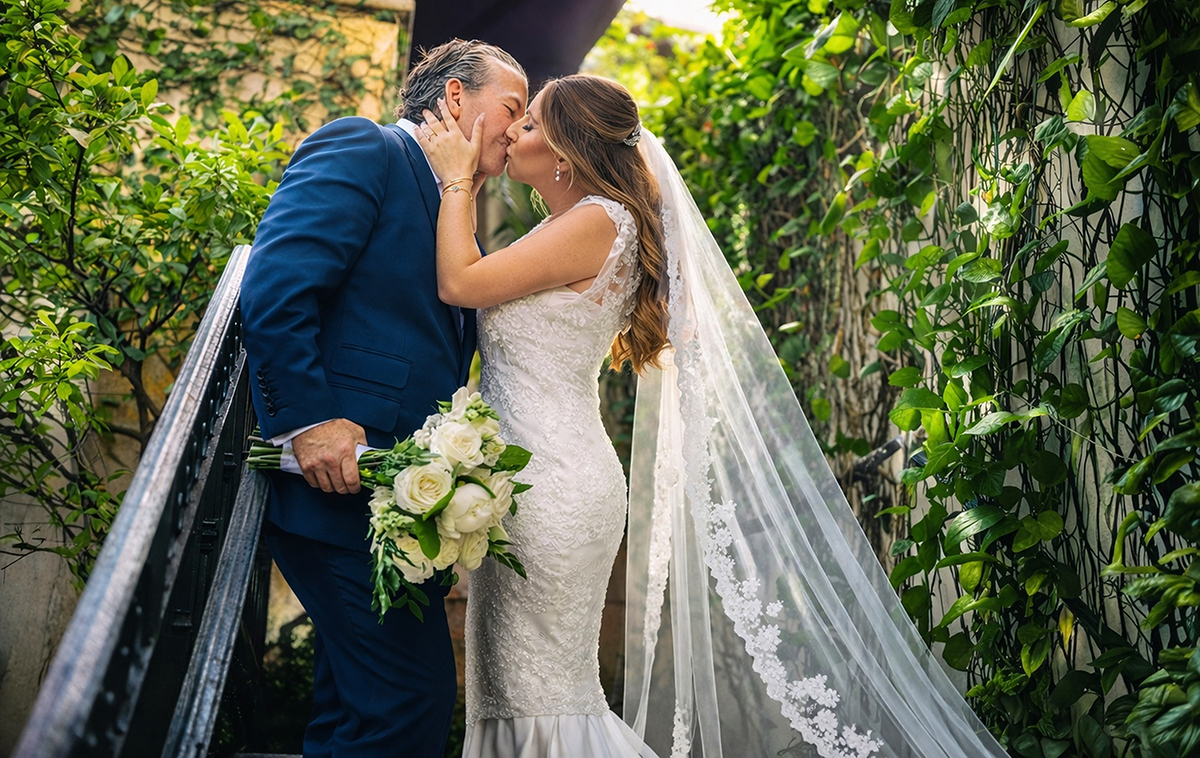 Bride and groom kissing on a garden staircase at Casa Tua Hotel Miami Beach during an intimate Jewish wedding