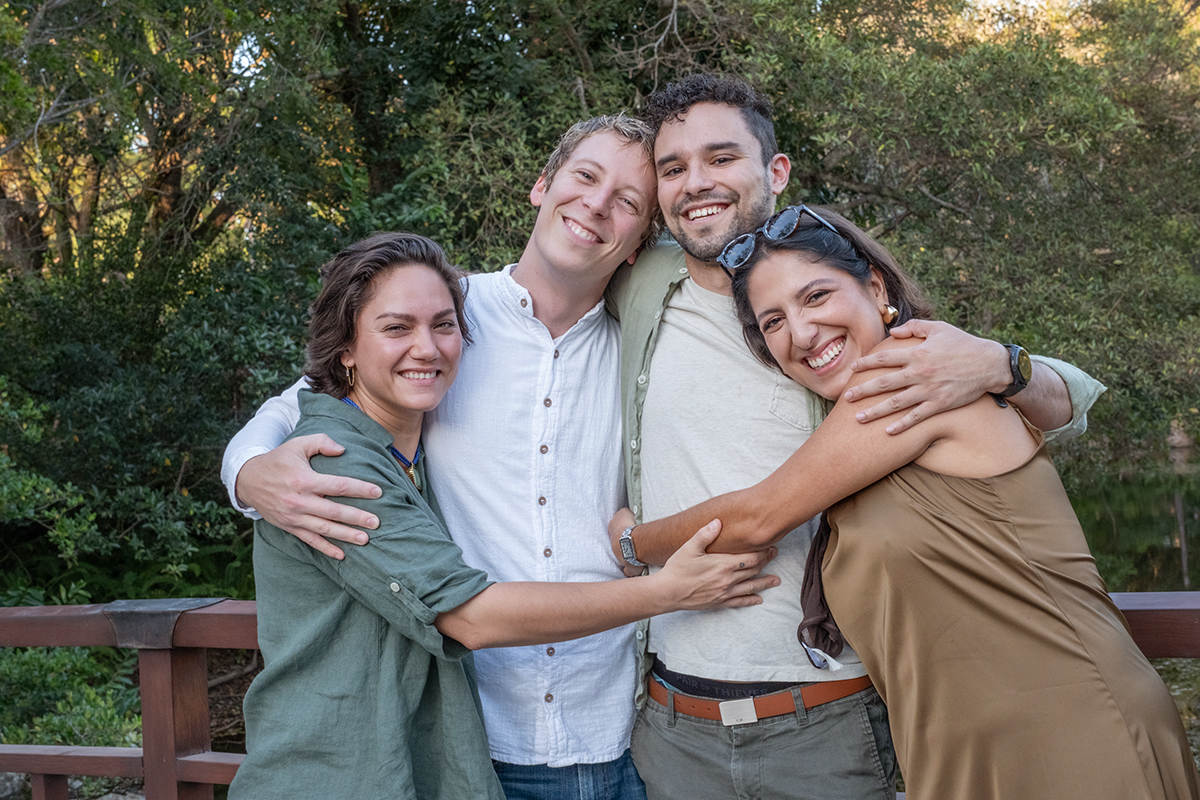 LGBTQ+ proposal photographer at Morikami Museum capturing Steve and Sam celebrating their surprise engagement with close friends in Delray Beach, Florida.
