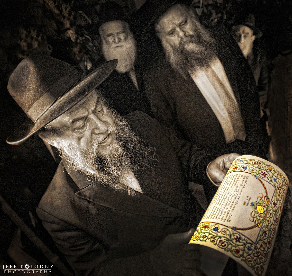 Rabbi holding and reading ornate ketubah during traditional Jewish wedding ceremony surrounded by guests