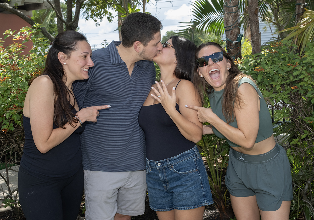 Jacob and Lauren celebrate their engagement with Jacob's sisters following a surprise marriage proposal at Putt'n Around Delray Beach as everyone admires Lauren's new engagement ring.