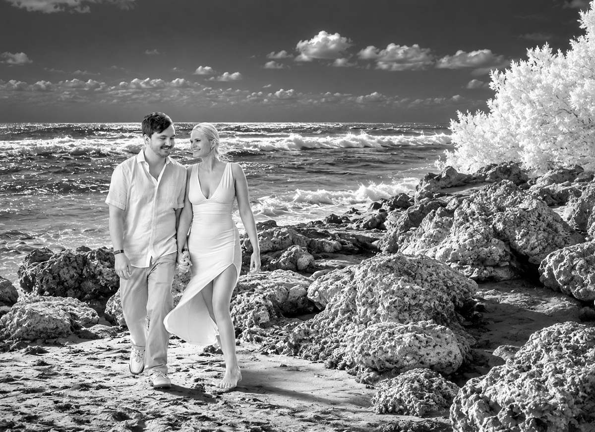 Infrared portrait of Josh and Rachael walking beside the ocean after their Boca Raton marriage proposal