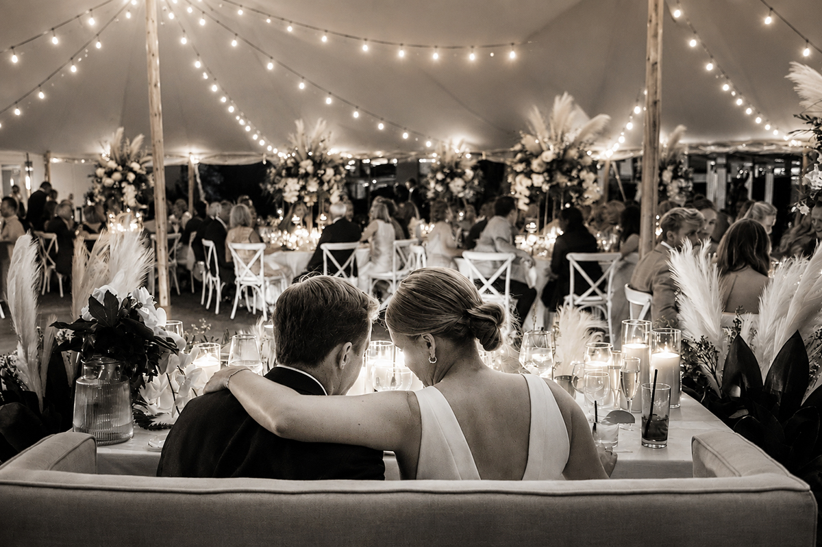 Bride and groom sitting together at their candlelit wedding reception at The Boca Raton Beach Club